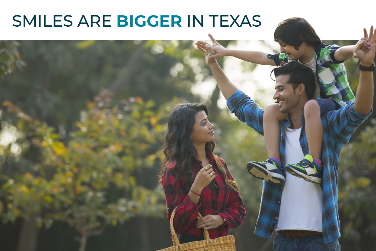 A family smiles at one another at a day out in Texas.