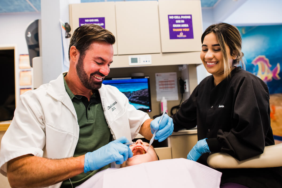 CDP's Dr. Chad Evans and hygienist working on young patient.