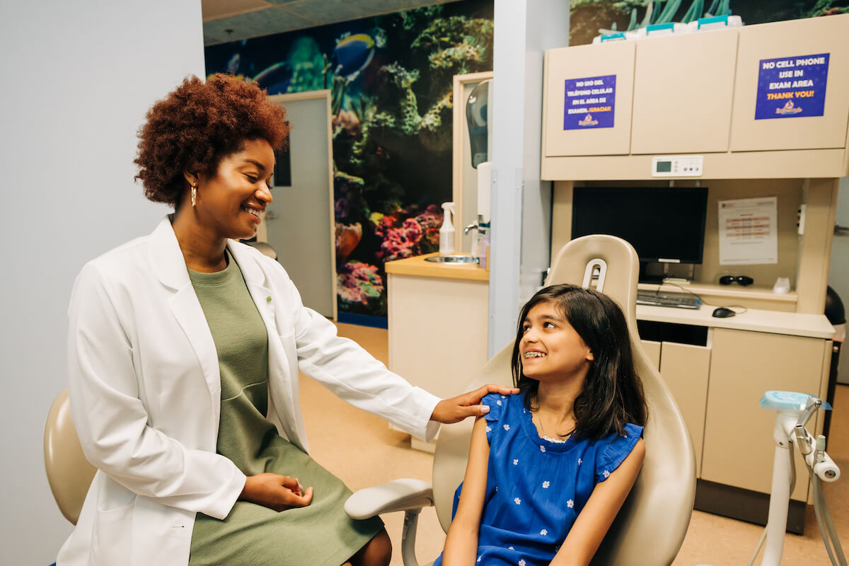 CDP Orthodontist comforting young, female patient.