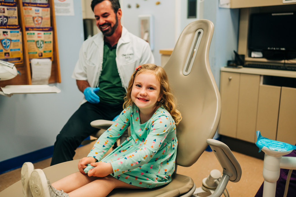 Young female patient smiling in the dentist chair. The funny thing is that many of those same dentists who feel hesitant about working with kids end up being the ones who love it the most.