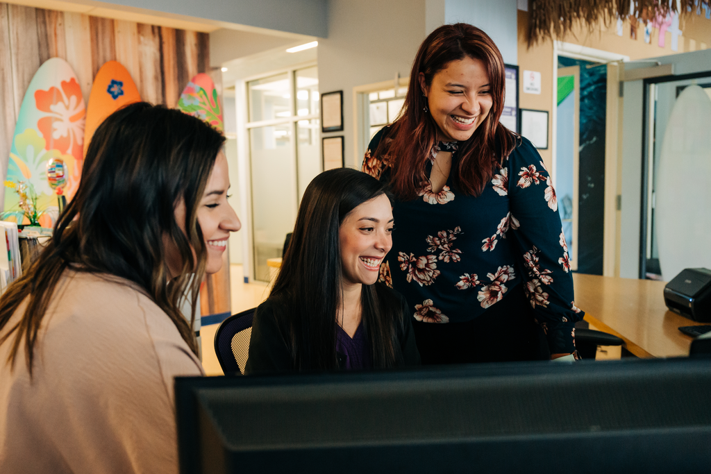 Front desk staff in dental setting. The benefits of a well-organized dental practice start when patients walk in the door.