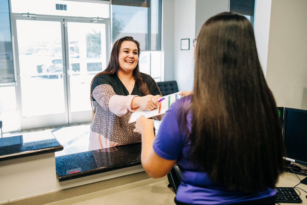 CDP is committed to improving healthcare access for underserved populations. That’s why we choose strategic locations for our practices and accept Medicaid. Reception helps a patient to fill out paperwork.