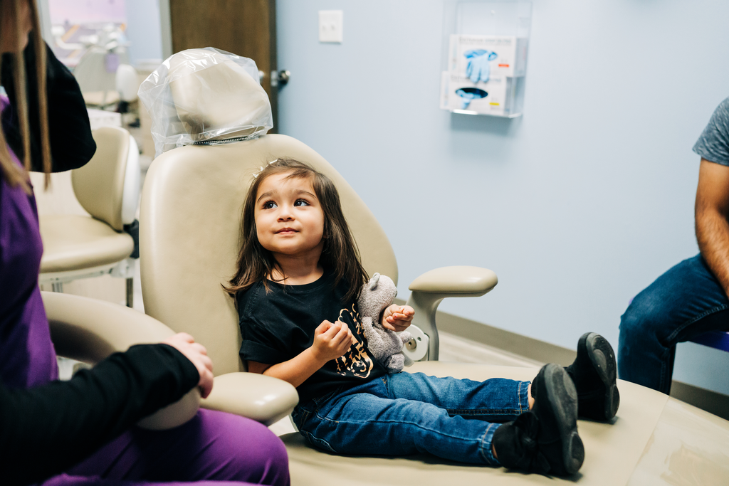 Young patient looking up at hygienist.